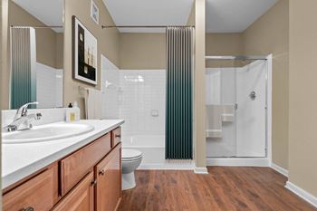 A bathroom with a toilet, sink, and shower.